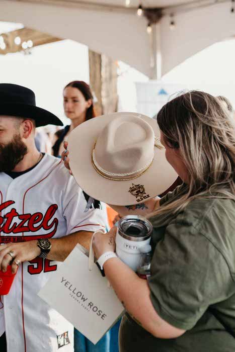 Guest choosing a premium hat at the Hat Branding Bar