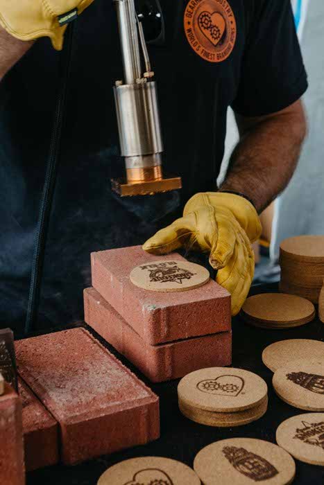 Live branding iron customizing a hat patch
